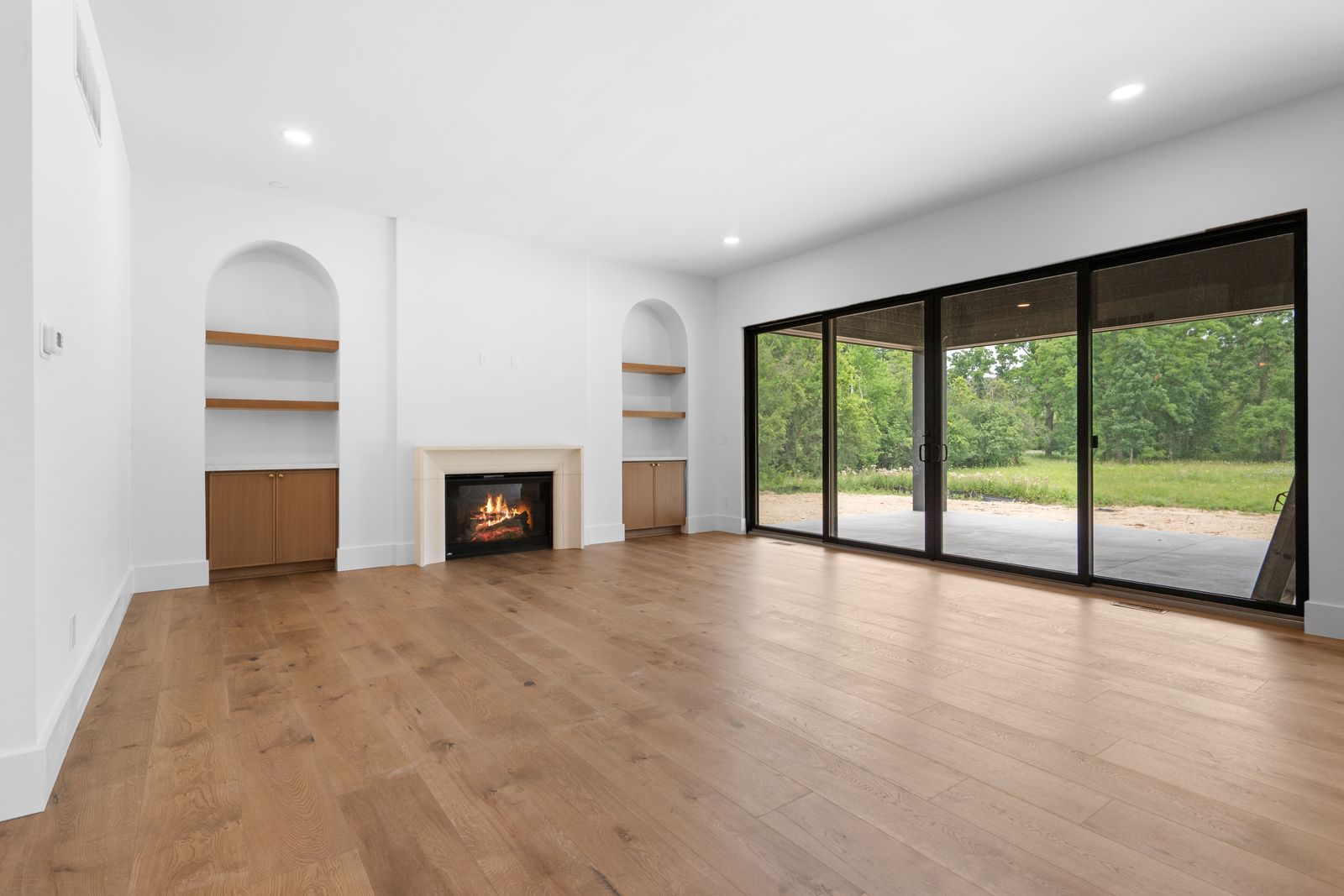 Great room with fireplace and built-in shelving in a recently completed Kensington home