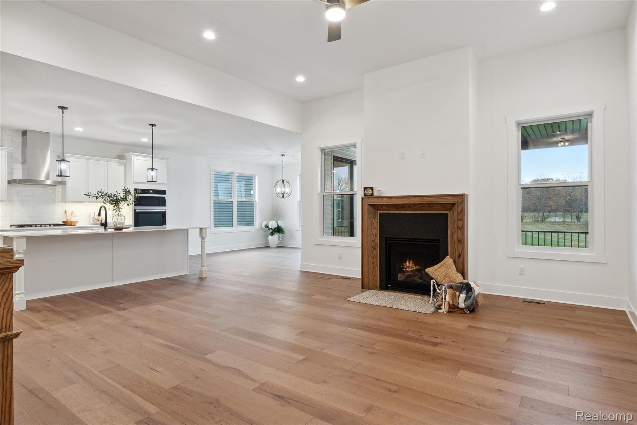 Great room with fireplace and kitchen beyond